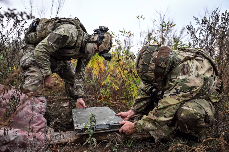 Ukrainian National Police officers set up Starlink terminal at positions in Donetsk region