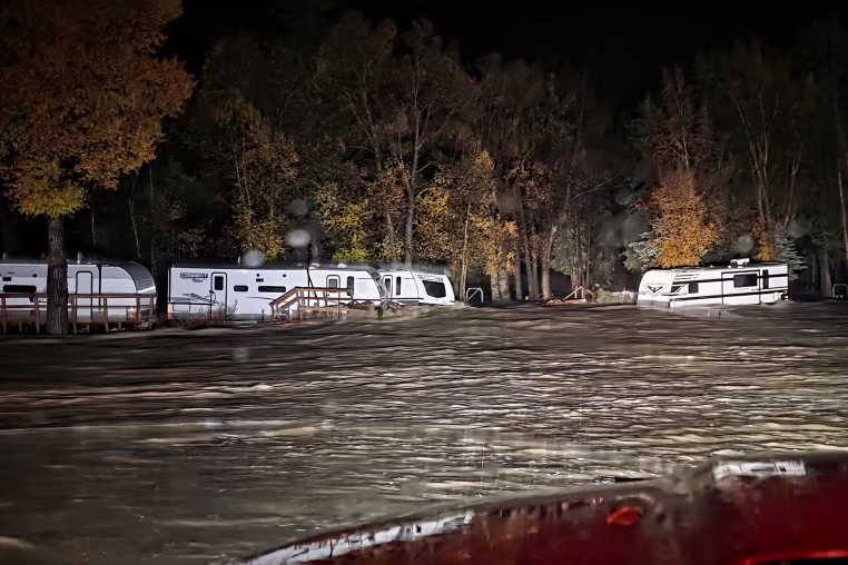 Camping trailers surrounded by high flood waters.