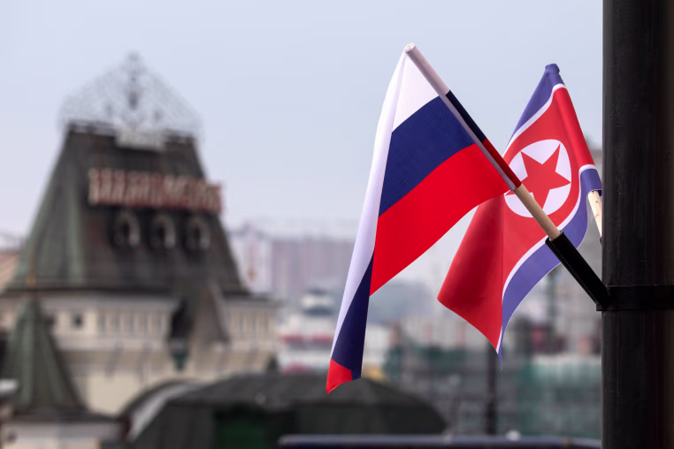 Flags of Russia and North Korea are seen.