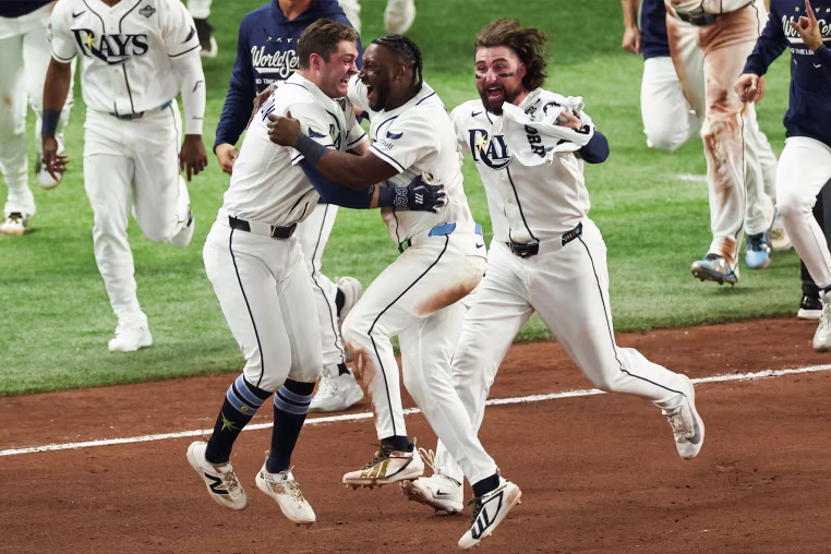 Ben Williamson #15 of the Tampa Bay Rays celebrates with Jorge Mateo #9 and Ryan Vilade #26 after hitting a walk-off single during Game Four of the 2026 World Series presented by Capital One between the Milwaukee Brewers and the Tampa Bay Rays at Tropicana Field on Tuesday.