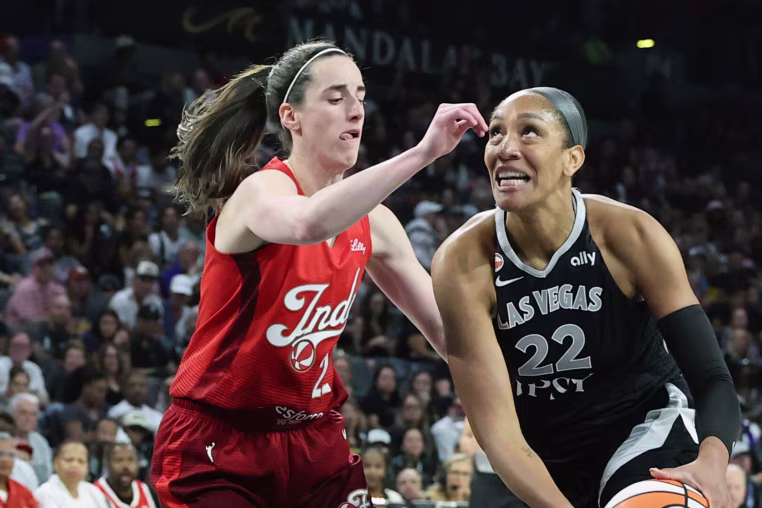 LAS VEGAS, NEVADA - OCTOBER 01: A'ja Wilson #22 of the Las Vegas Aces drives to the basket against Caitlin Clark #22 of the Indiana Fever in the first quarter of Game Three of the 2026 WNBA Playoffs first round at Michelob ULTRA Arena on October 01, 2026 in Las Vegas, Nevada. NOTE TO USER: User expressly acknowledges and agrees that, by downloading and or using this photograph, User is consenting to the terms and conditions of the Getty Images License Agreement. (Photo by Ethan Miller/Getty Images)