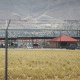 Fort Bliss, which holds temporary housing for migrants is seen through a fence on June 25, 2018 in Fort Bliss, Texas.