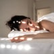 Woman Lying On Bed At Home, with light shining on her face