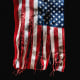 Image: tattered and torn American flag.