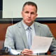 Former Louisville Police officer Brett Hankison examines a document as he answers questions from the prosecution March 2, 2022, in Louisville, Ky.