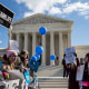 Image: Pro-choice advocates and anti-abortion advocates rally outside of the Supreme Court. Some of the visible signs read,\"#TeamLife\", \"Protect Women, Protect Life\" and \"Don't agree with abortion? Don't have one\".