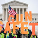 Image: Activists hold out signs with letters that spell out,\"Gun Safety\" in front of the Supreme Court building.
