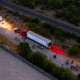 Image: Aerial view showing law enforcement officers investigating a tractor trailer.