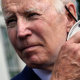 Image: President Joe Biden removes his mask.