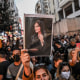 Image: A protester holds a portrait of Mahsa Amini during a demonstration in support of Amini in Istanbul