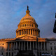 Image: Capitol Police Officers stand on the East Plaza of the Capitol Campus as the dome of the U.S. Capitol Building is illuminated by the rising sun on Capitol Hill.