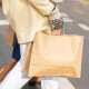 Woman holding a brown shopping bag