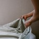 Woman Puts Sheet on Bed