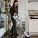 Woman vacuuming in her kitchen