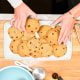 Overhead of two hands grabbing cookies