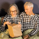Couple in bed, opening gifts