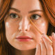 Woman looking in the mirror with Hydrating concealers