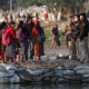 Image: Mexican immigration agents review the IDs of Guatemalan travelers at an access point to the Suchiate River, on the border between Guatemala and Mexico, near Ciudad Hidalgo, Mexico.