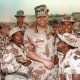 Chairman of the Joint Chiefs of Staff General Colin Powell and members of the 132nd MP Company in Saudi Arabia on Dec. 22, 1990.