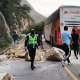 People stand near debris that fell as a result of a 7.5-magnitude earthquake in Peru on Nov. 28, 2021.