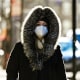 A woman wears a medical grade KN95 mask