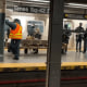 Police and transit crew members investigate a deadly assault on a Times Square subway platform.