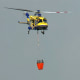 Image: A firefighting helicopter crew in Texas works to put out an active wildfire in Bastrop County.