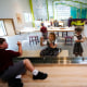 School children draw on a glass panel during a preview of the Louisiana Children's Museum in New Orleans on Aug. 27, 2019.