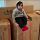 Ayaansh Kumar sits on some on boxes containing some of the furniture he ordered from Walmart.com.