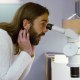 Jonathan Van Ness looks through a microscope in the fourth episode of Netflix's "Getting Curious with Jonathan Van Ness."