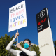 A protester holds a sign at a rally in support of the employee walkout outside of Netflix's offices in Los Angeles on Oct. 20, 2021.