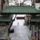 A pedestrian crosses Grant Street behind the Dragon Gate, an entrance to Chinatown in San Francisco on April 4, 2020.