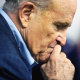 Former New York Mayor Rudy Giuliani pauses while addressing supporters of former President Donald Trump during a Columbus Day gathering at a Trump campaign field office in Philadelphia on October 12, 2020.