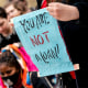People hold signs during a Cancel Student Debt rally outside the U.S. Department of Education in Washington on April 4, 2022.