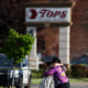 Image: People hug outside the scene of a shooting at a Tops supermarket in Buffalo, N.Y. on Saturday.