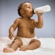 A baby drinks from a bottle circa 1975.