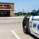 A Dallas police cruiser is stationed outside Hair World Spa on May 14, 2022, where a shooter opened fire and injured three Korean women.