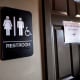 A unisex sign and the "We Are Not This" slogan are outside a bathroom at Bull McCabes Irish Pub on May 10, 2016 in Durham, N.C.