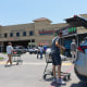 The Hair World Salon, the scene of a shooting that injured three women of Korean descent in Dallas, left, and shoppers at the Komart Marketplace in Dallas, which features Korean and other Asian specialties.