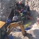 Rescue crews try to free two teenagers from a 10ft hole in the beach that collapsed on them at Tom Rivers, N.J., Tuesday.