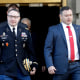 National Security Council aide Lt. Col. Alexander Vindman, at left, walks with his twin brother, Army Lt. Col. Yevgeny Vindman in Washington on Nov. 19, 2019.