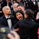 A protestor is removed from the red carpet