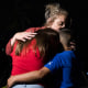 A woman embraces two children outside Willie de Leon Civic Center in Uvalde, Texas, on May 24, 2022.