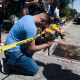Joseph Avila prays while holding flowers honoring the victims killed in Tuesday's shooting at Robb Elementary School in Uvalde, Texas, on May 25, 2022.