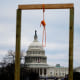 A noose is seen on makeshift gallows as supporters of President Donald Trump gather on the West side of the Capitol