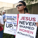 Jennifer Weed, left, and Nisha Virani, both of Birmingham, Ala., demonstrate outside Southern Baptist Convention's annual meeting, during a rally in Birmingham, Ala., on June 11, 2019.