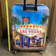 A child’s body was found inside this closed hard case suitcase with a distinctive Las Vegas design on its front and back.