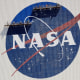 Workers on scaffolding repaint the NASA logo at the Kennedy Space Center in Cape Canaveral, Fla., on May 20, 2020.