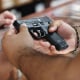 A customer looks at a handgun