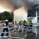Firefighters put out the fire in a mall hit by a Russian missile strike